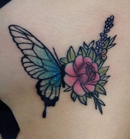 A small butterfly tattoo features vivid blue wings gracefully intertwined with delicate pink roses