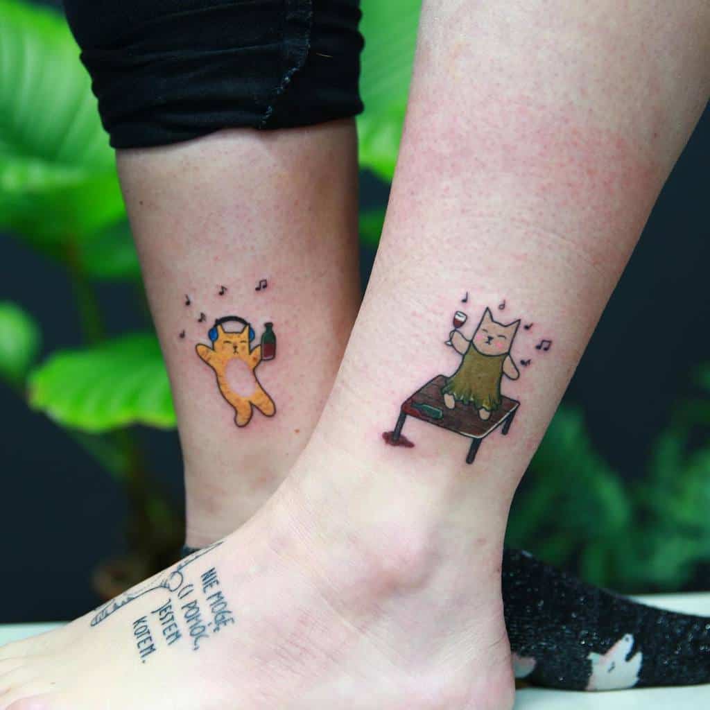 Two calf tattoos of dancing cartoon cats with drinks; one on each leg