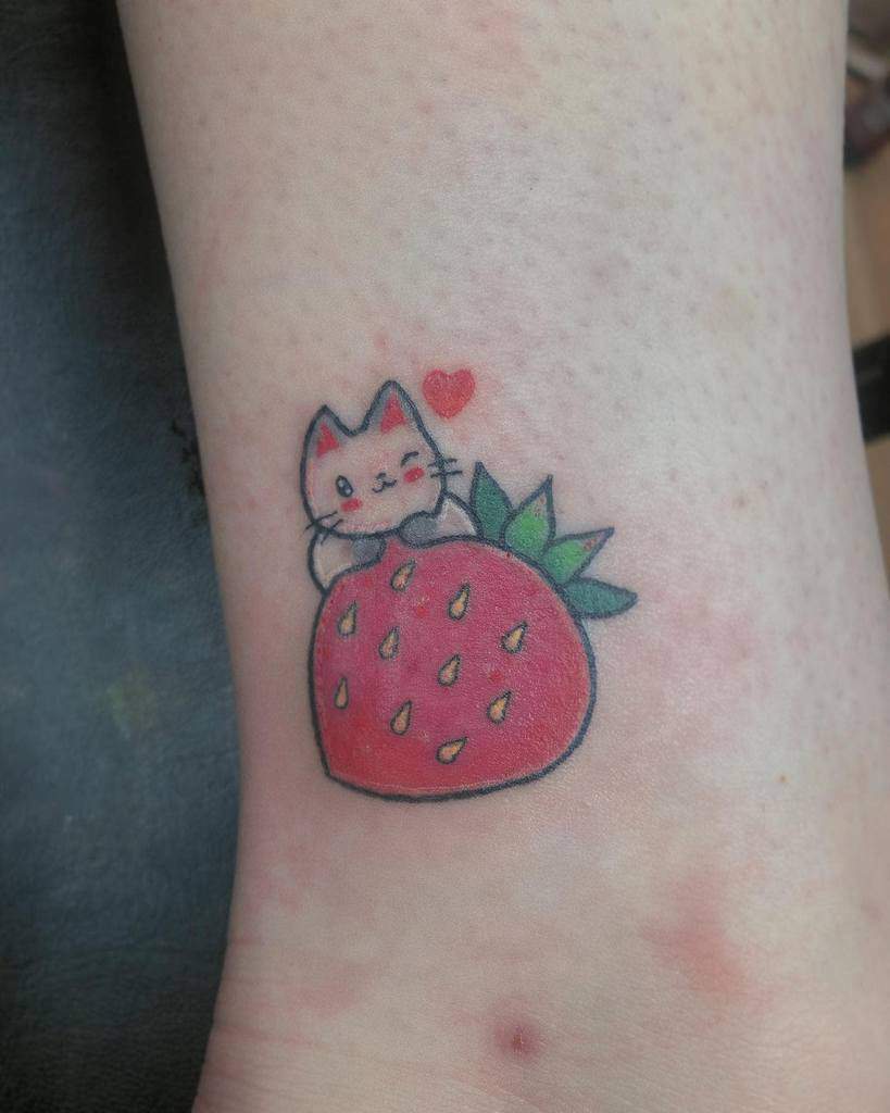 Cute cat hugging a strawberry tattoo with a small red heart
