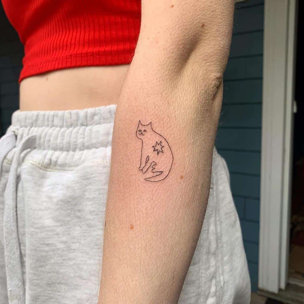 Line drawing cat tattoo on person's forearm