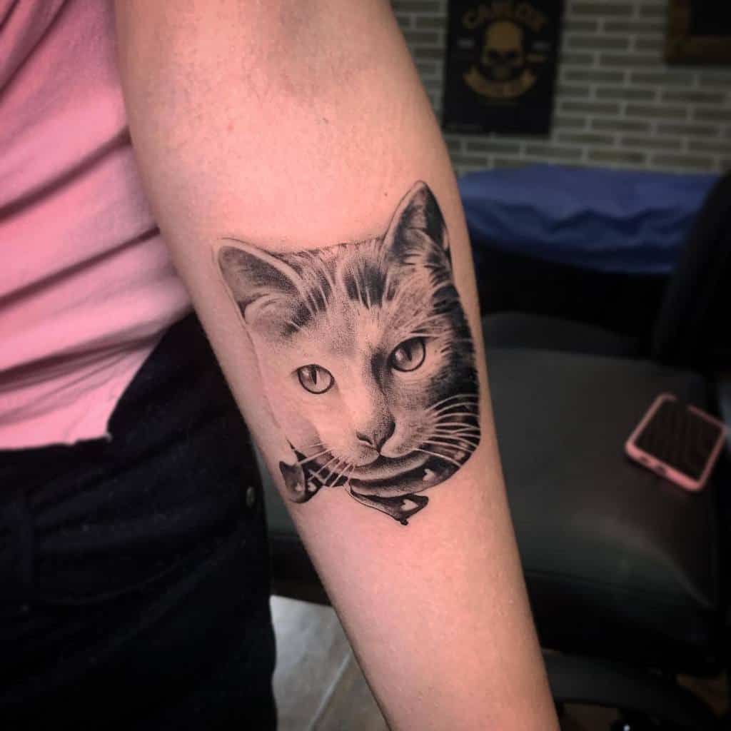 Black and white cat tattoo on a forearm
