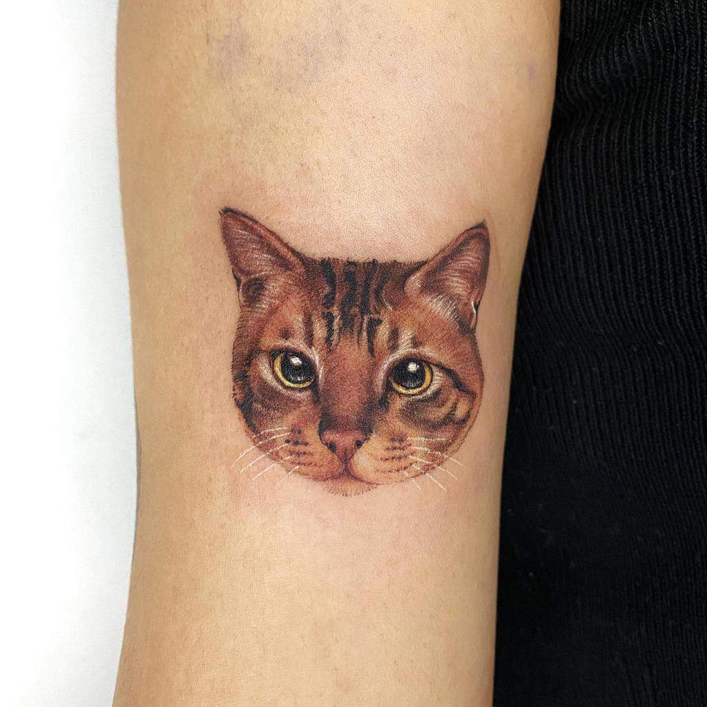 Tattoo of a cat face on an arm