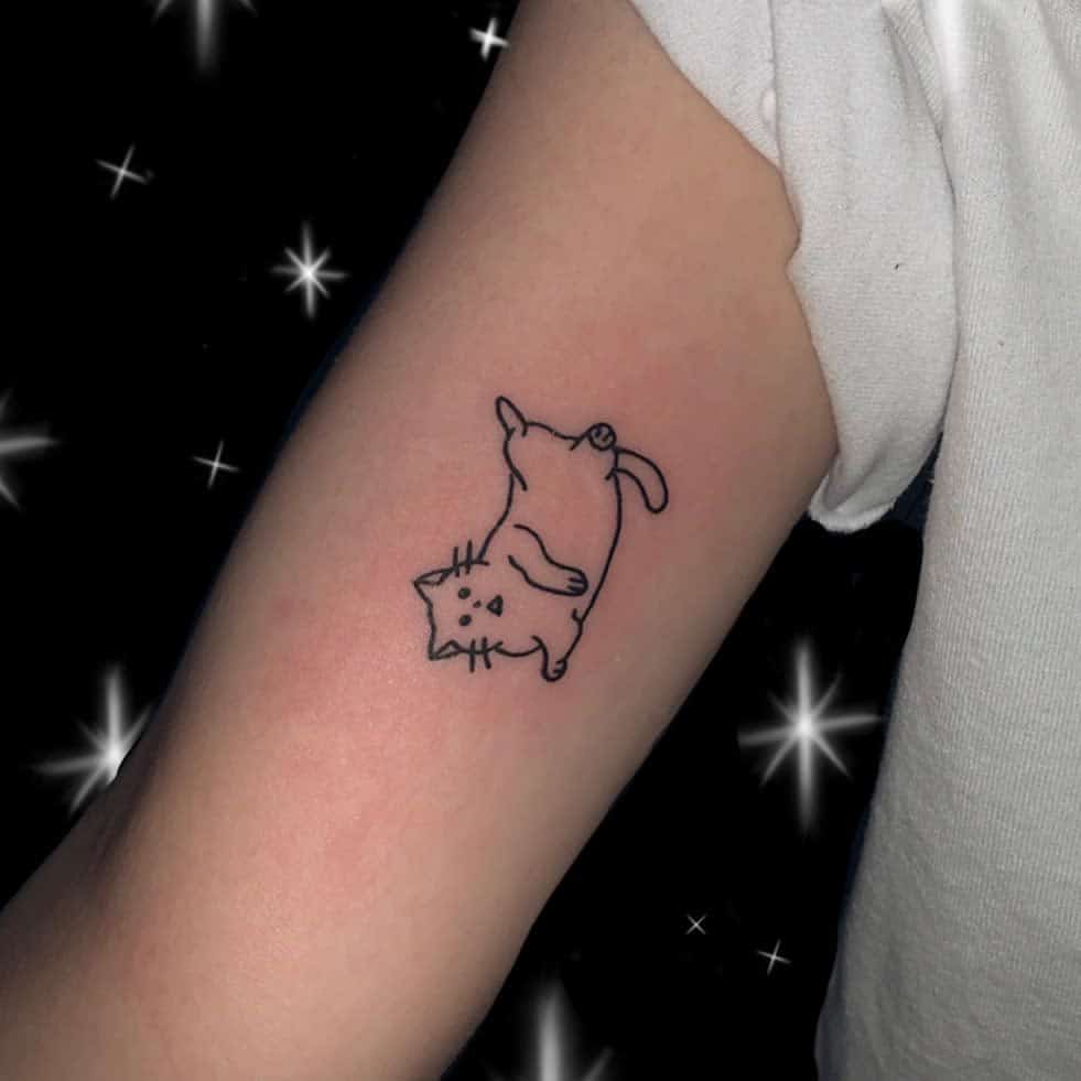 Tattoo of a playful cat on an arm