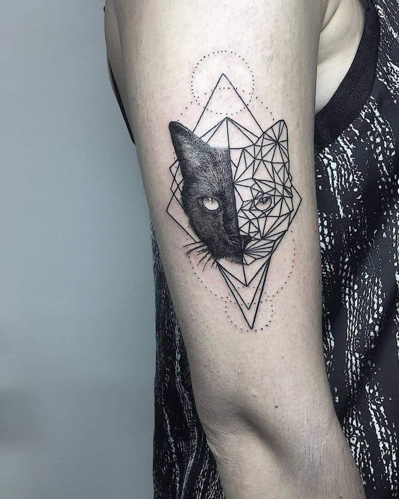 Tattoo of a cat's face, half realistic and half geometric, on an upper arm