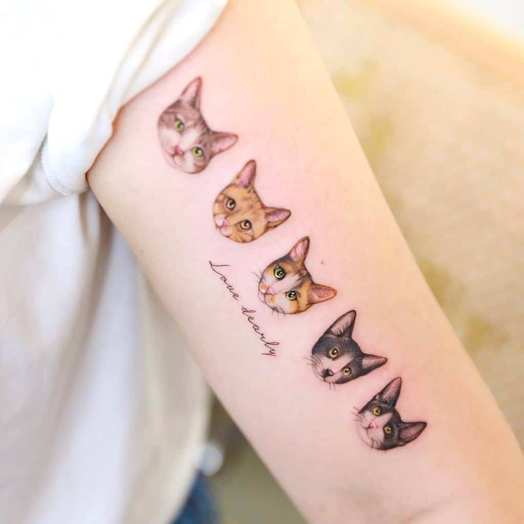 Tattoo of five cat portraits in a row on a person's arm