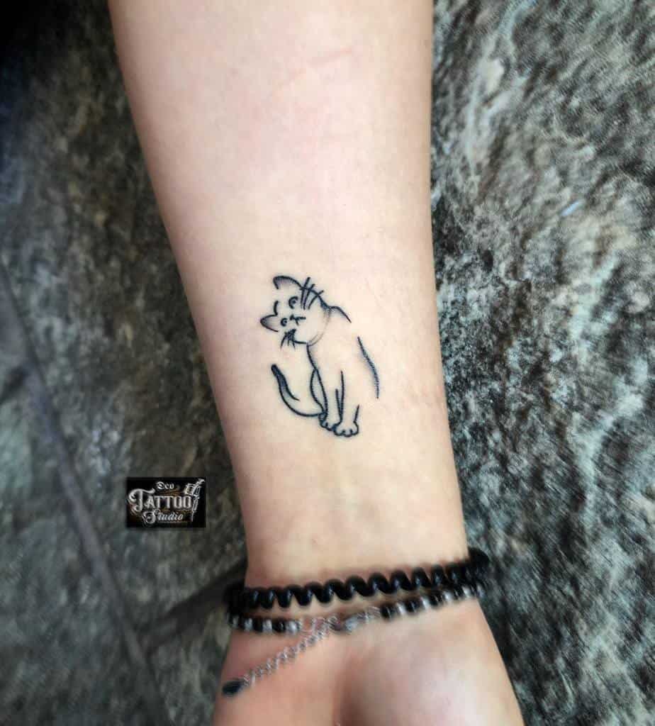 Line art cat tattoo on a wrist