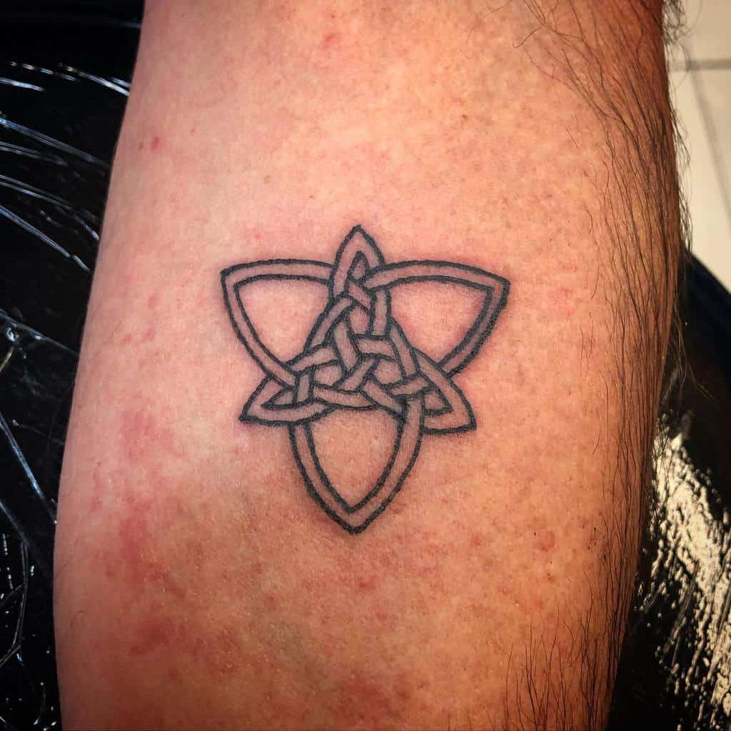 Celtic knot tattoo with triquetra design on forearm