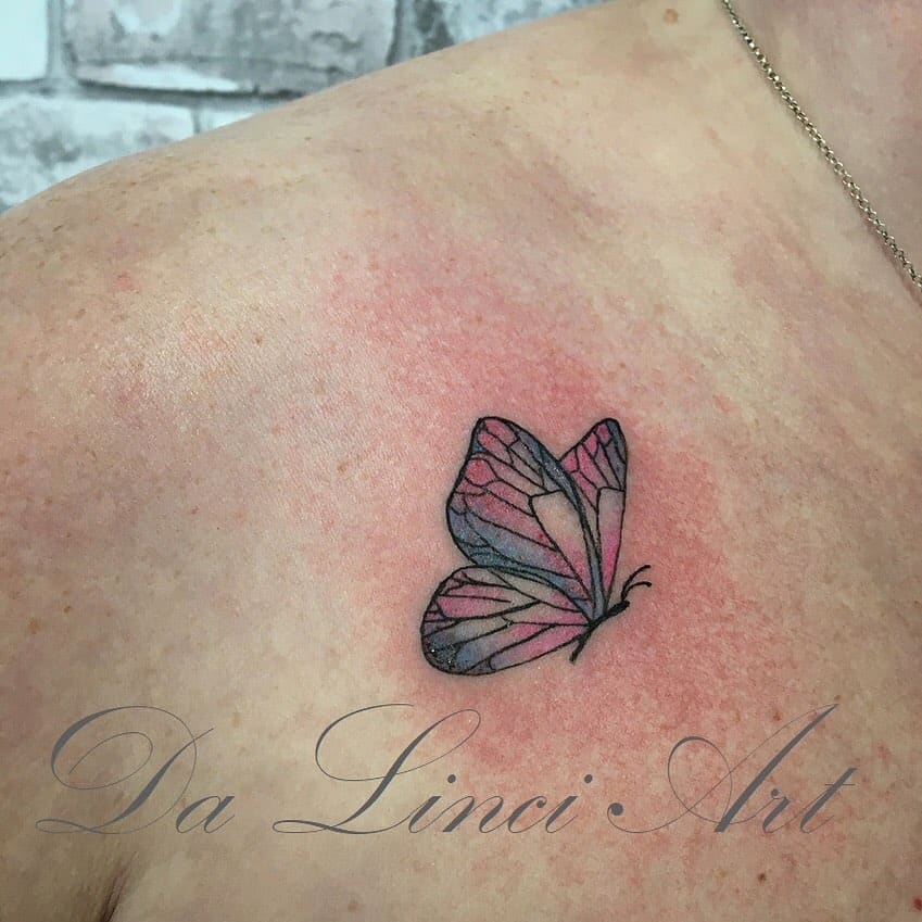 A small butterfly inked gracefully on a person's shoulder
