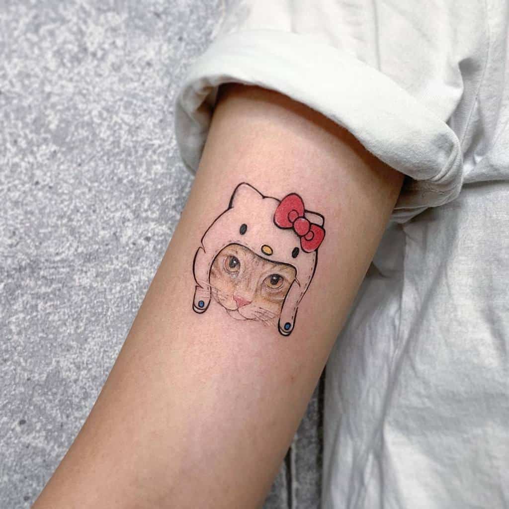 Tattoo of a cat wearing a cute hat, resembling a cartoon character, on a forearm