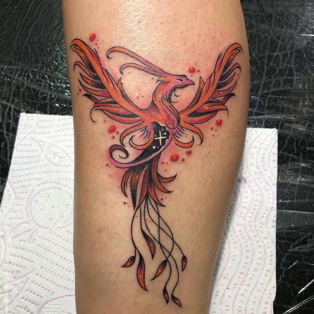 A vibrant phoenix tattoo with a flowing tail elegantly adorns the skin
