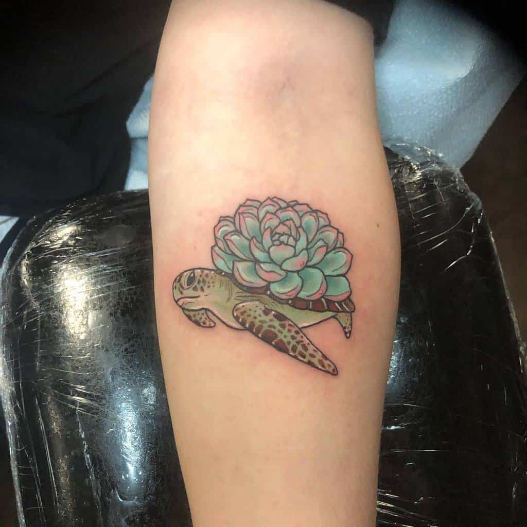 Tattoo of a turtle with a succulent shell on an arm