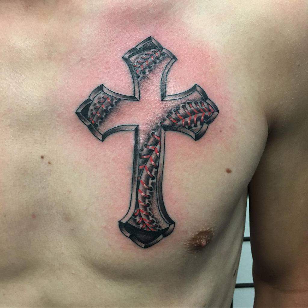 Chest tattoo of a cross with baseball stitching design, showing red and black details