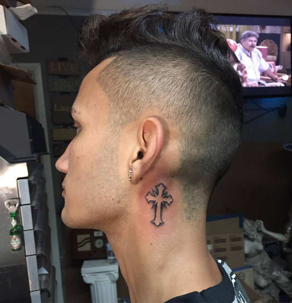 Ornate cross tattoo on the neck with bold lines and intricate detailing, making a striking statement of faith