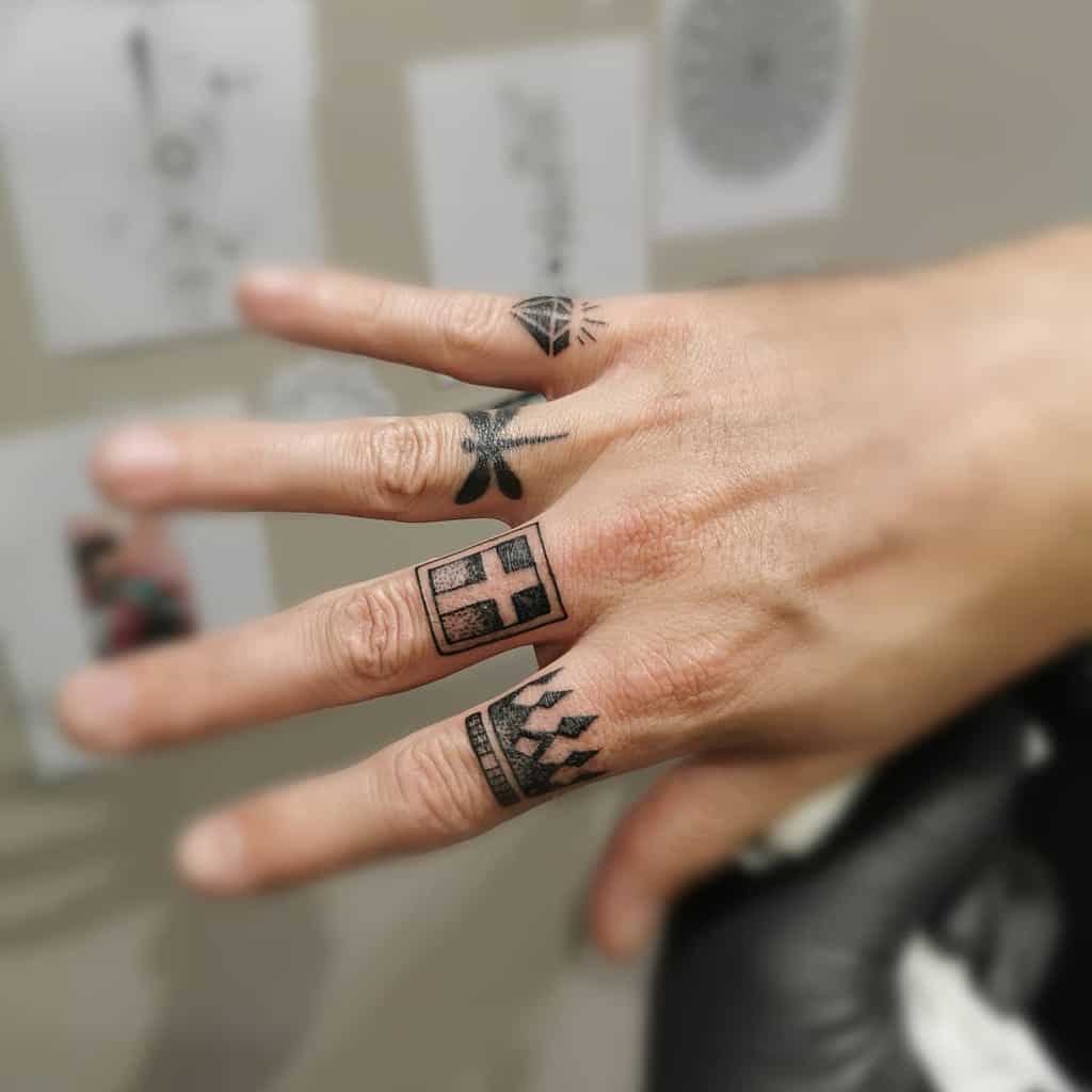 Geometric cross tattoo on the finger, surrounded by bold symmetrical patterns for a modern and striking design