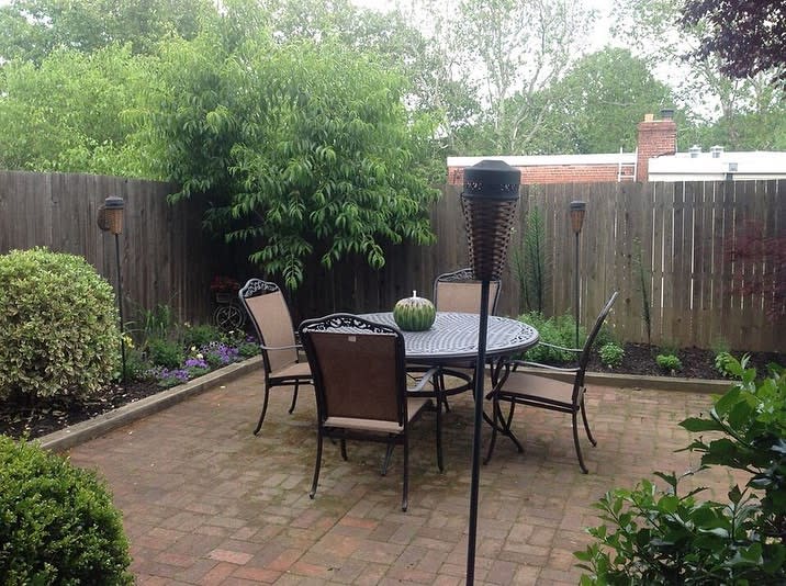 small backyard paver patio round table with chairs