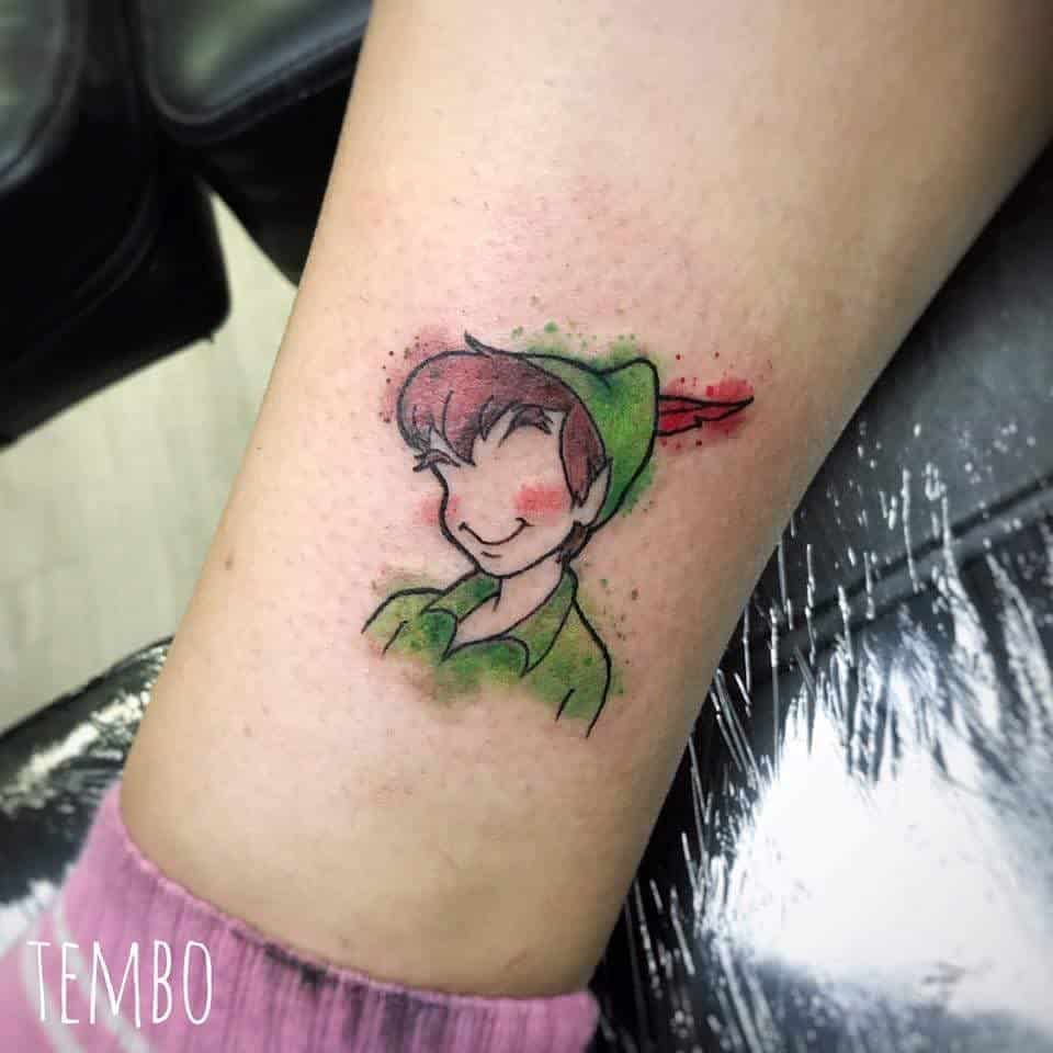 A colorful tattoo of Peter Pan with a whimsical, watercolor effect, playfully designed on the ankle