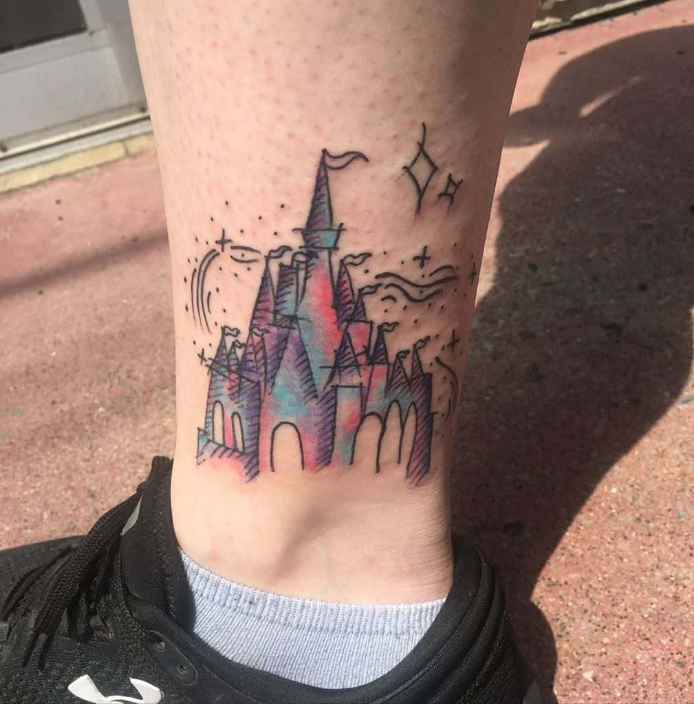 A colorful Disney castle tattoo with whimsical stars and swirls, designed in a sketch style on the ankle