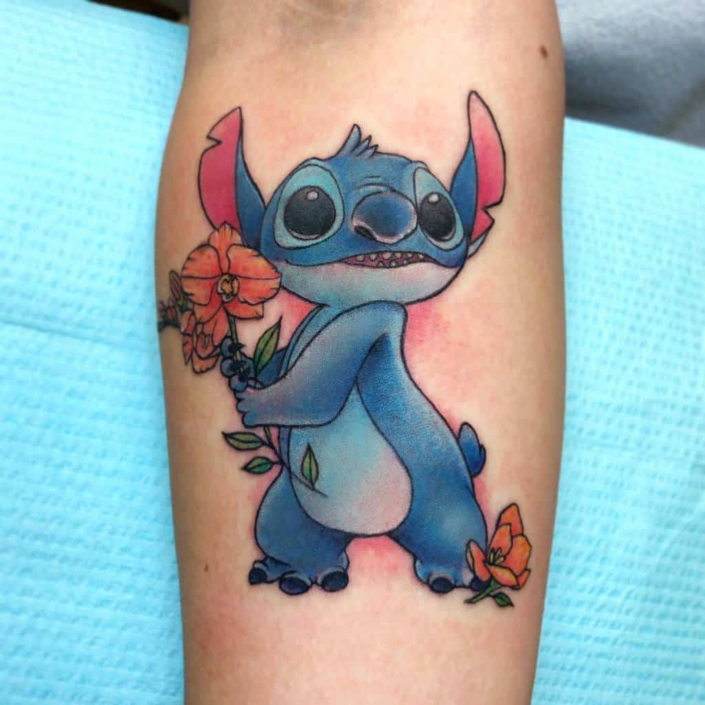 A vibrant tattoo of Stitch from Lilo & Stitch, holding a bright orange flower with a playful expression, designed with soft colors and fine details on the forearm