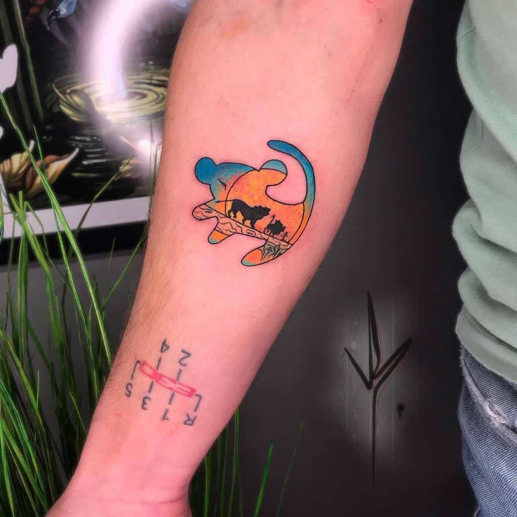 A vibrant and artistic tattoo of The Lion King, with a sunset color palette blending into the shape of Simba, creating an iconic and serene moment from the film