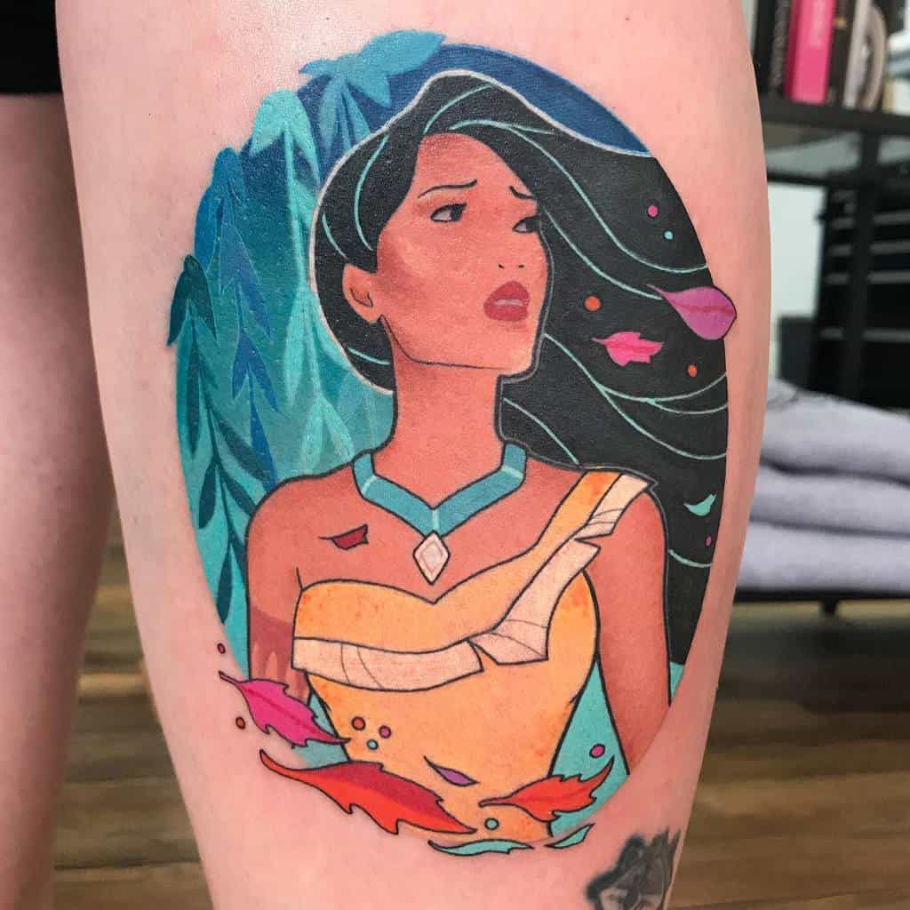 A beautiful tattoo of Pocahontas, surrounded by colorful falling leaves, symbolizing her connection to nature and freedom