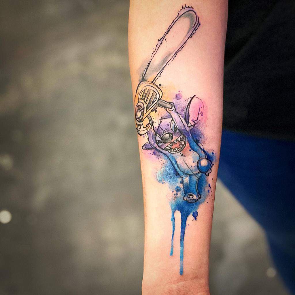 A vibrant watercolor tattoo of Stitch from Lilo & Stitch, joyfully wielding a chainsaw, surrounded by playful blue and pink splashes