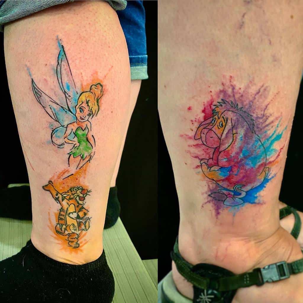 A watercolor tattoo with Tinker Bell, Eeyore, and Tigger, blending vibrant colors to capture their whimsical personalities