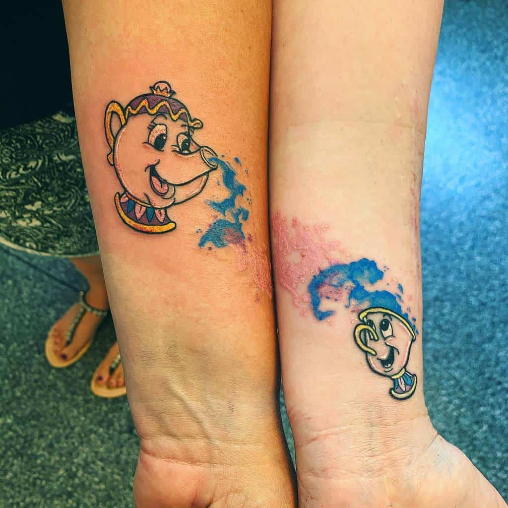 A charming set of "Beauty and the Beast" tattoos featuring Mrs. Potts and Chip, with whimsical watercolor splashes capturing their magical essence