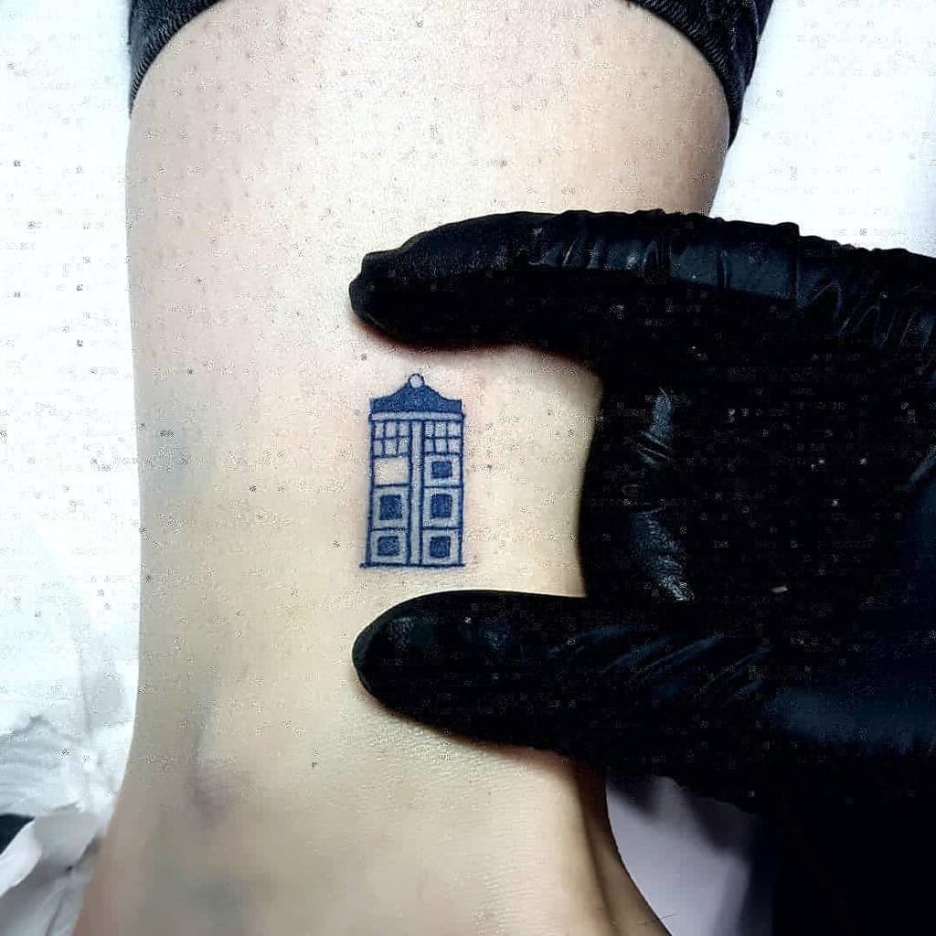 Minimalist tattoo of the TARDIS from 'Doctor Who', capturing the iconic police box design in a simple yet classic style