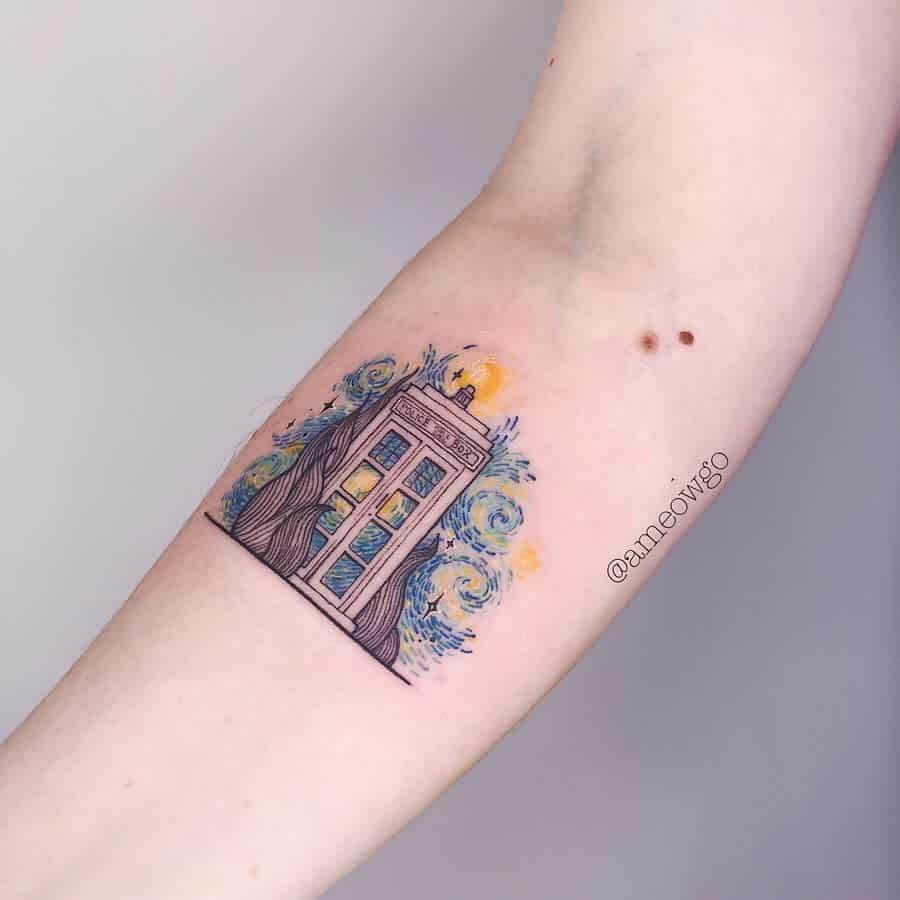 Colorful tattoo featuring the TARDIS from 'Doctor Who', surrounded by vibrant blue and yellow swirls