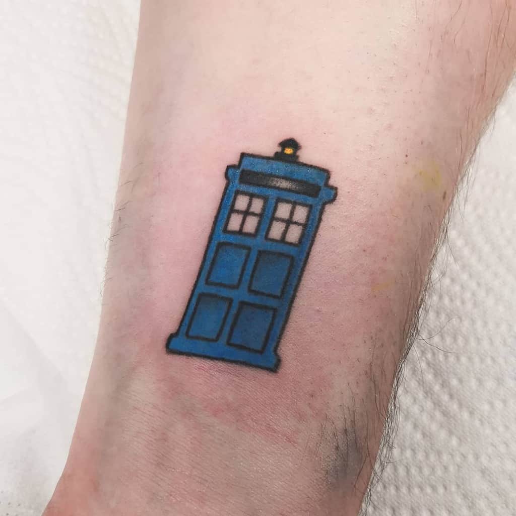 Simple yet striking Doctor Who tattoo, featuring a bold blue TARDIS with black outlines and a light blue glow