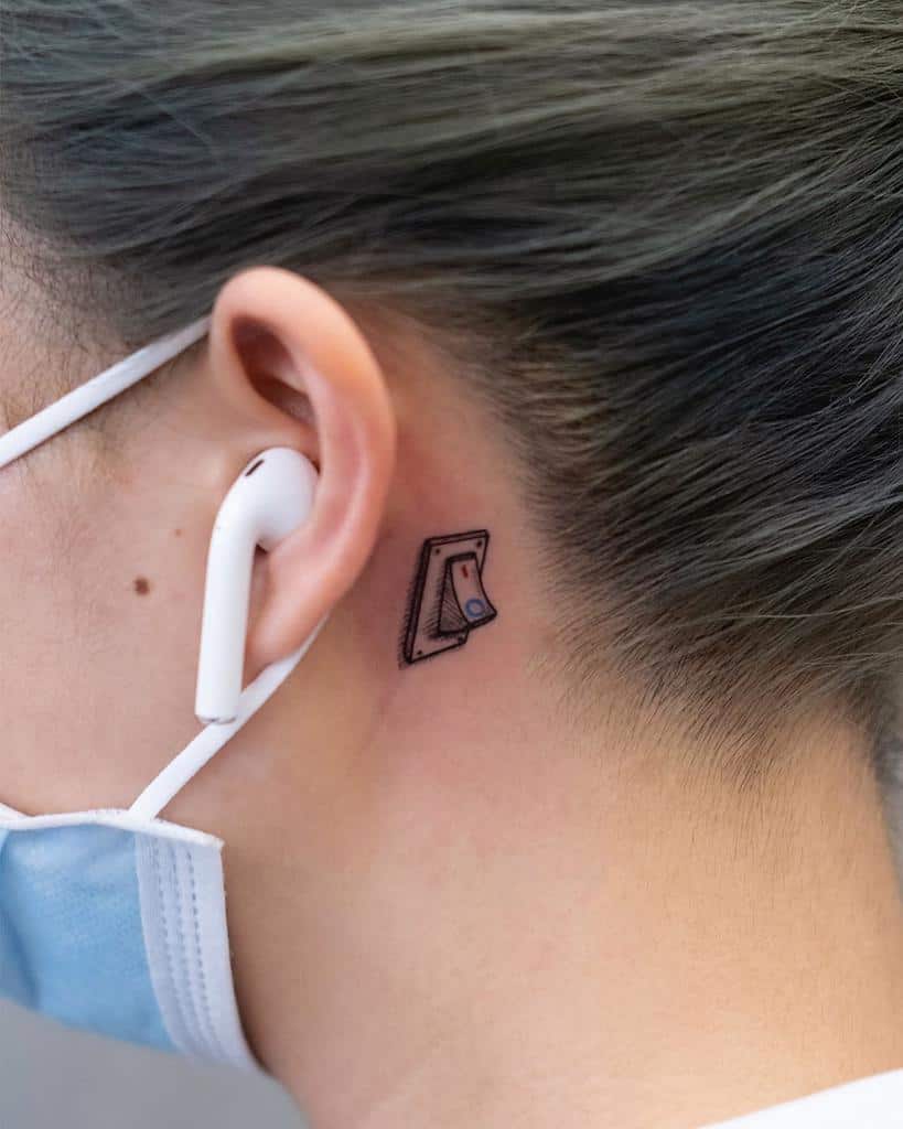 Minimalist light switch tattoo behind the ear, symbolizing control, energy, or a playful reminder to stay switched on or off