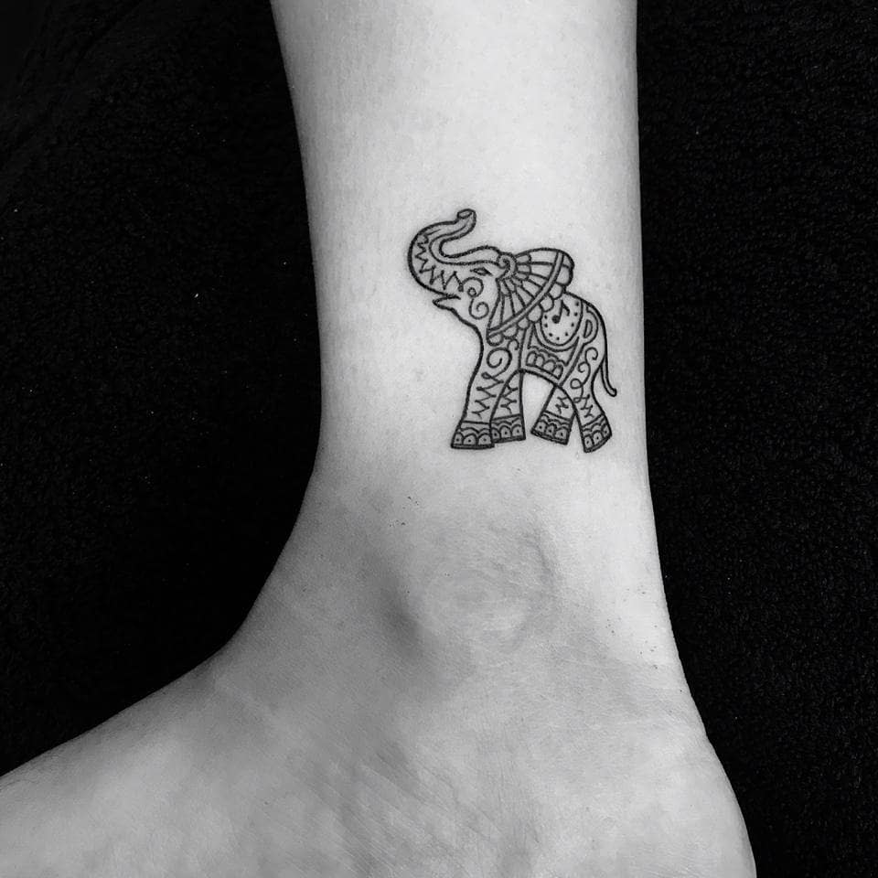 Intricate elephant tattoo with detailed patterns on the inner wrist