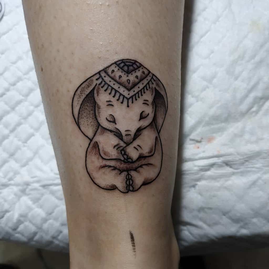 Intricate elephant tattoo with folded ears and a mandala-style headpiece, symbolizing peace and spirituality.