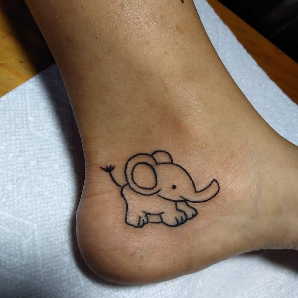 Minimalist elephant tattoo on an ankle, displaying simple lines and cute features