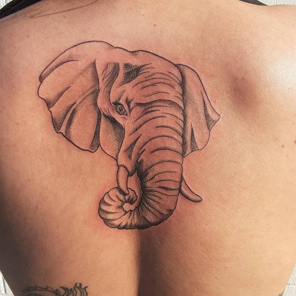 Tattoo of an elephant head on an upper back