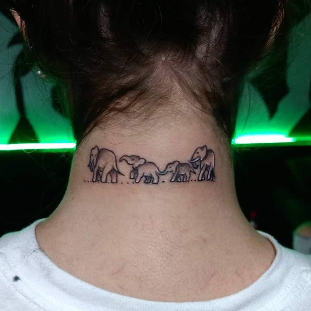 Tattoo of four elephants walking in a line on the back of a neck