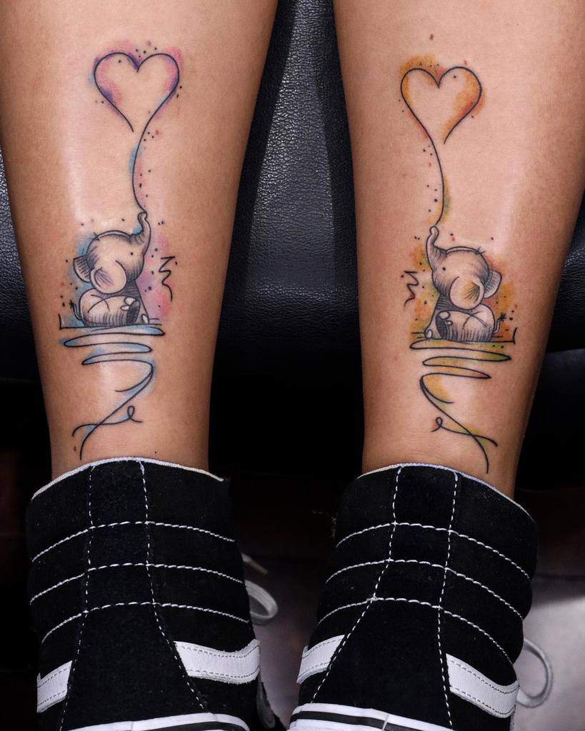 Cute elephant tattoos on legs, each with heart-shaped balloons and colorful swirls