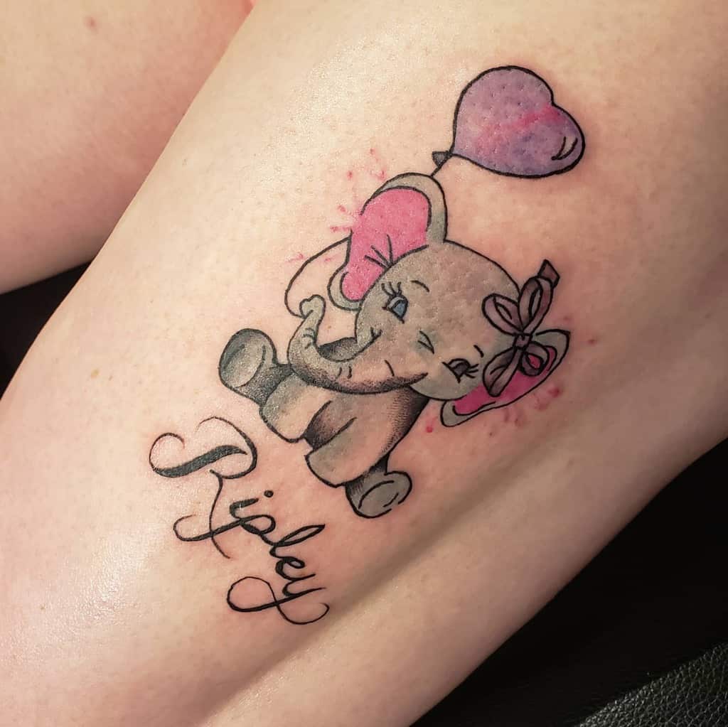 Tattoo of a smiling elephant holding a heart balloon, with "Ripley" written below