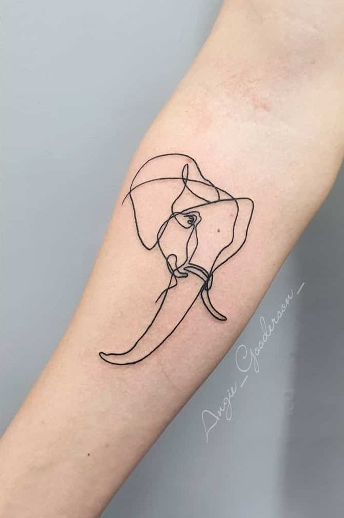 Minimalist single-line elephant tattoo on a forearm
