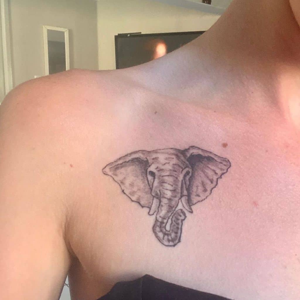 Tattoo of an elephant's head on a chest near the shoulder