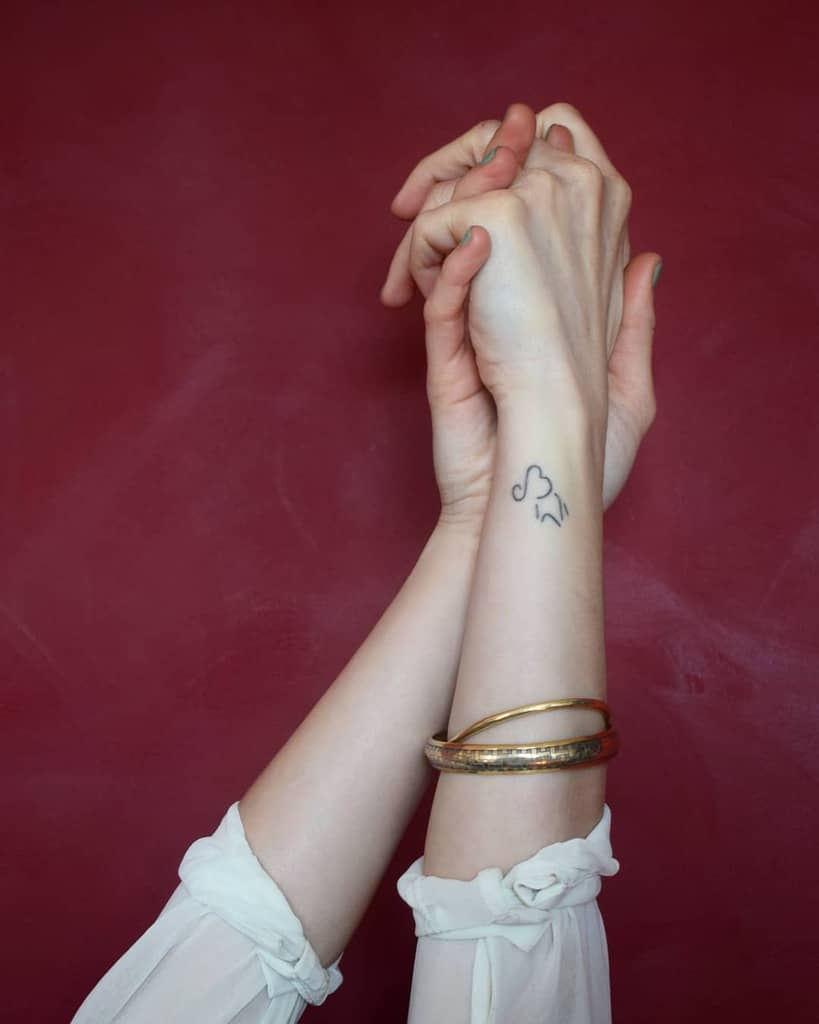 Small elephant line tattoo on a wrist