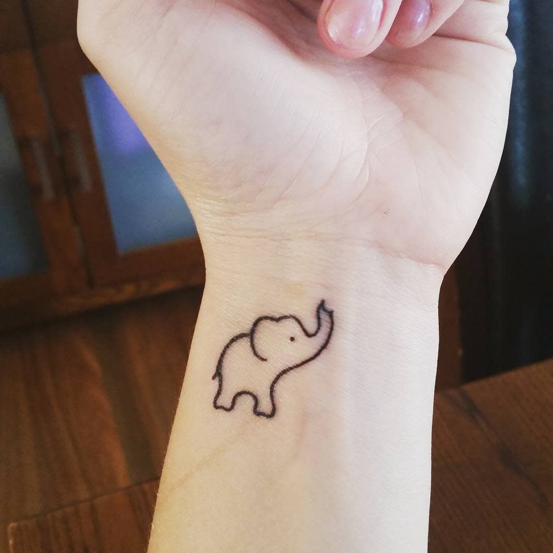 Minimalist elephant tattoo on a wrist