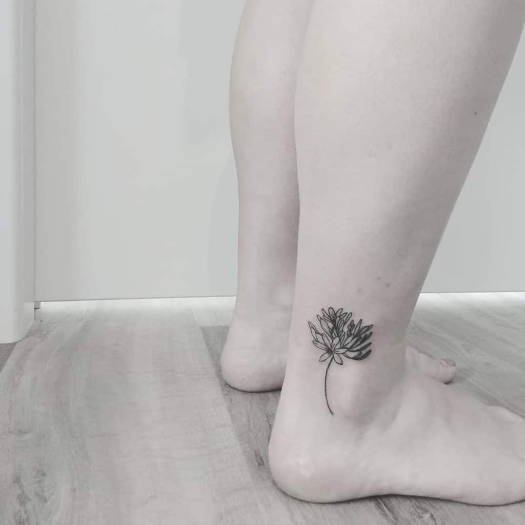 Black lotus tattoo on the back of a calf