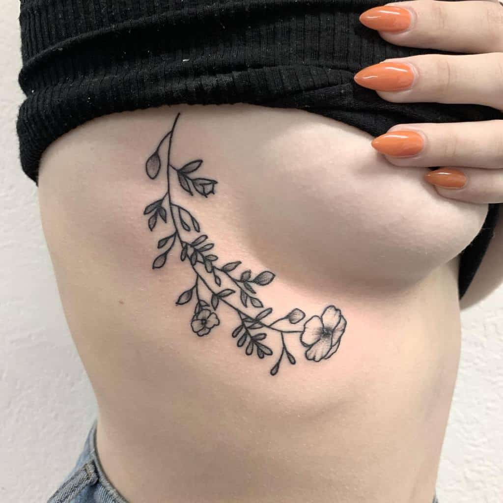 A floral tattoo on the side of a woman's torso