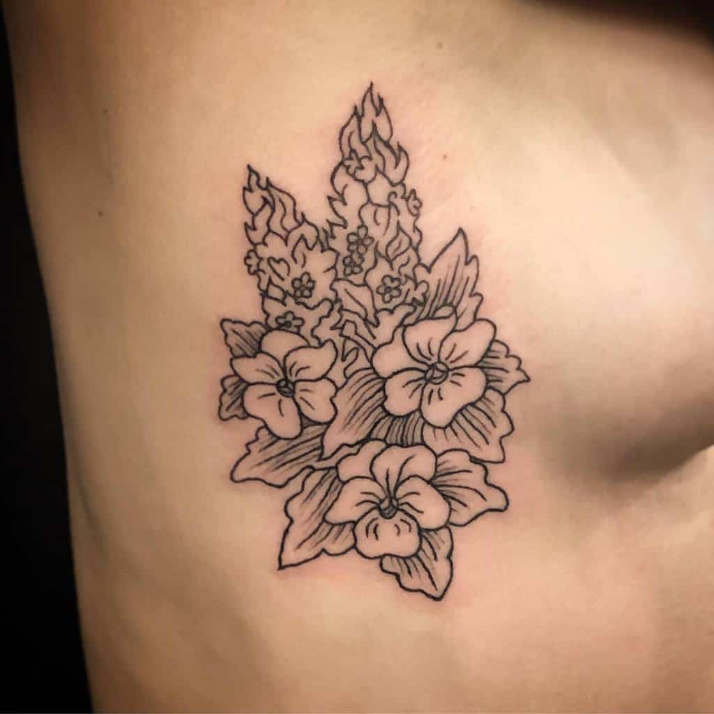 An outline tattoo featuring a delicate arrangement of flowers and leaves on the skin