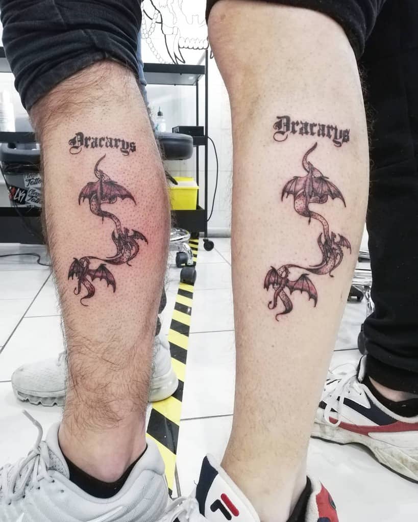 Matching Game of Thrones-inspired tattoos featuring two dragons intertwined beneath the word 'Dracarys,' symbolizing unity and the fiery spirit of House Targaryen