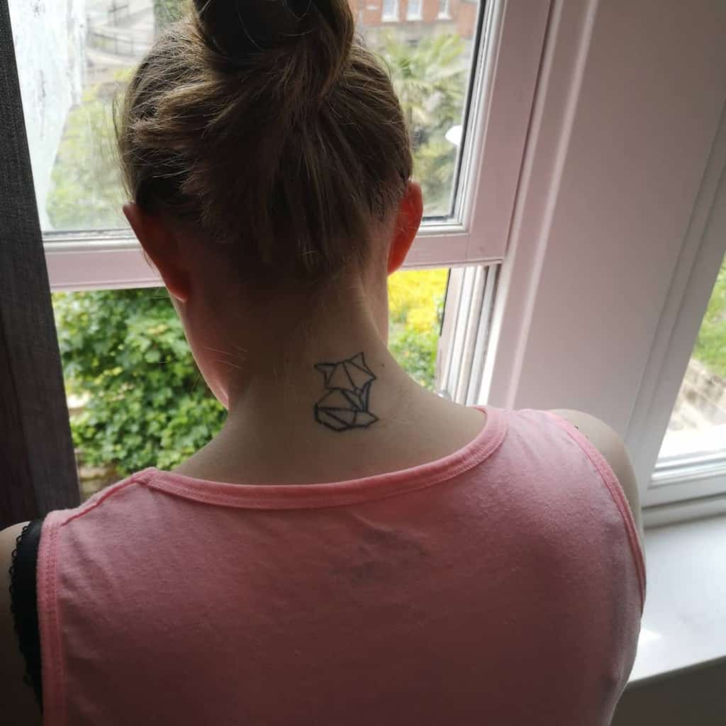 Geometric fox tattoo on the back of a person's neck