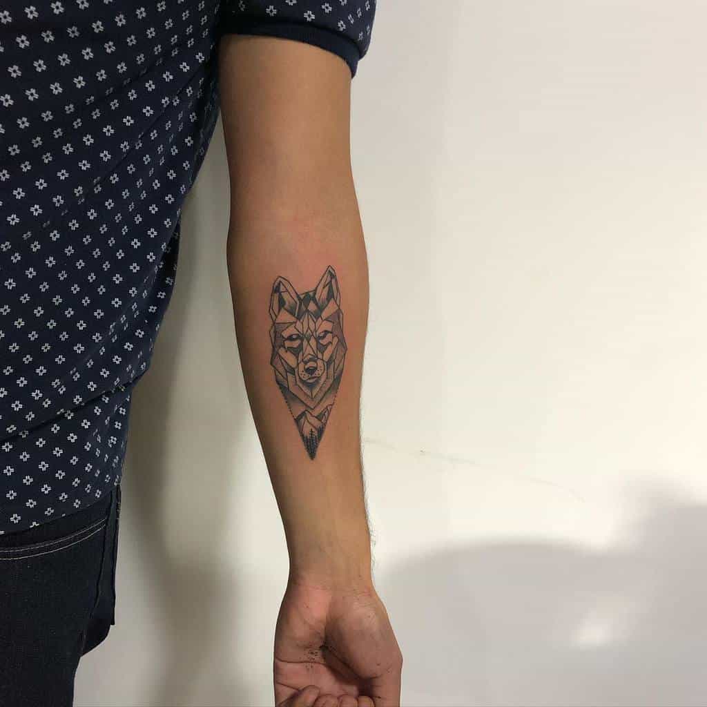 A stunning geometric tattoo featuring a sleek wolf design graces the forearm