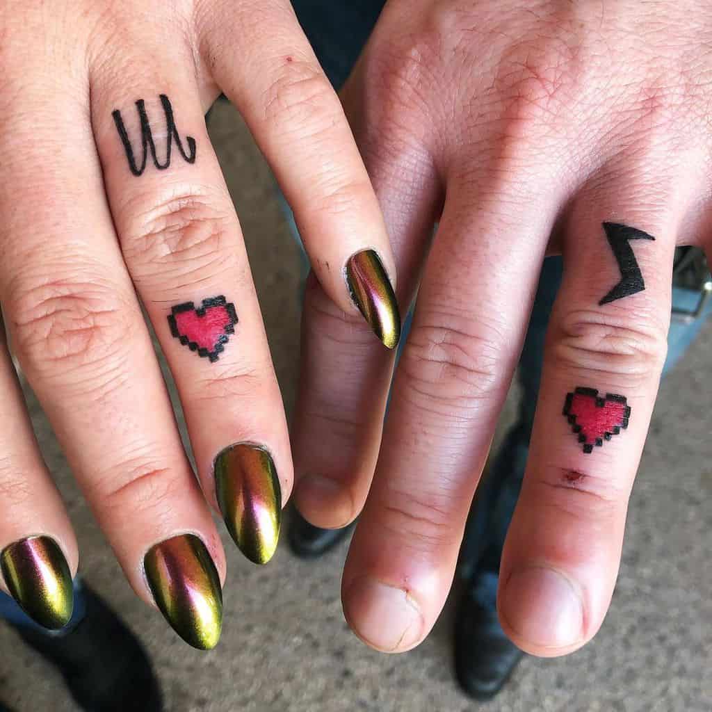 Pixelated red heart tattoos on fingers paired with minimalist symbols, including a zigzag and wave design, for a playful vibe