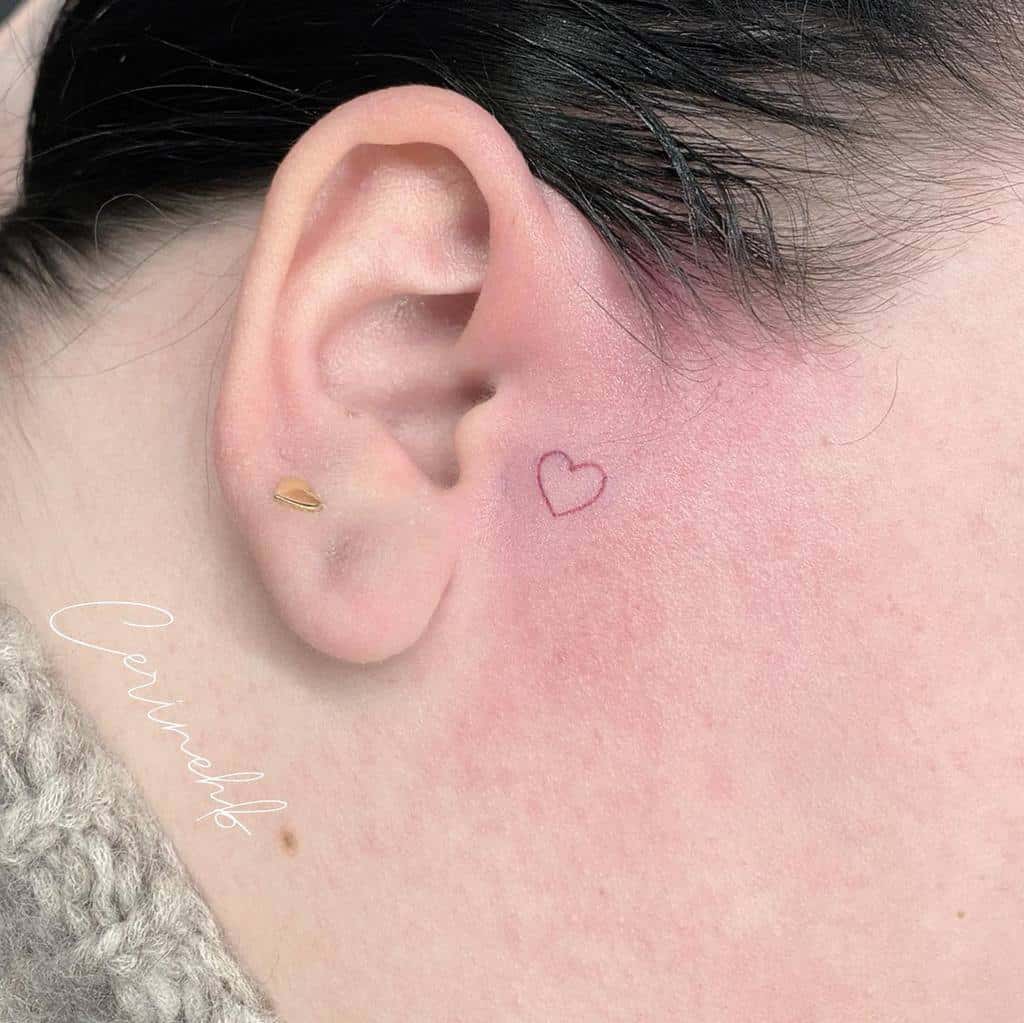 Small red heart tattoo near the ear
